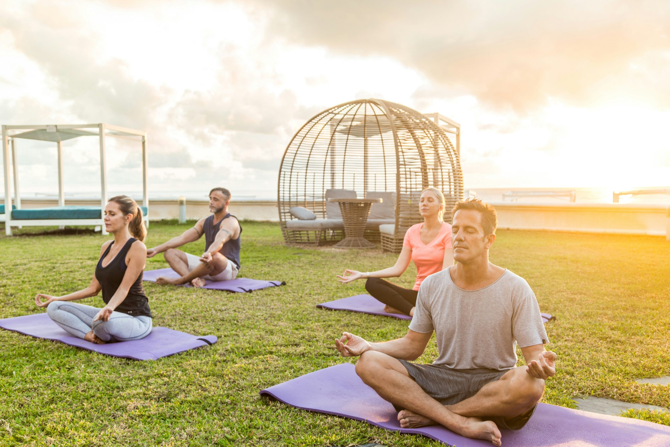 group of people doing yoga outside for relaxation